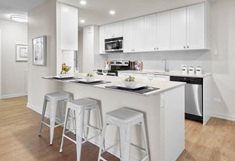 Panorama Apartments in Edmonton, ON kitchen with breakfast bar and upgraded cabinetry