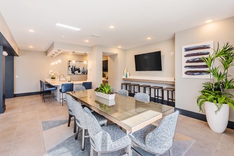 a dining room with a long table and chairs