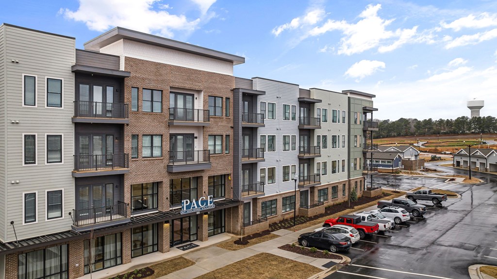 A row of apartment buildings with the name "PACE" on the front.