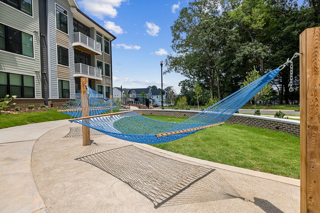 A blue hammock is strung between two wooden posts.