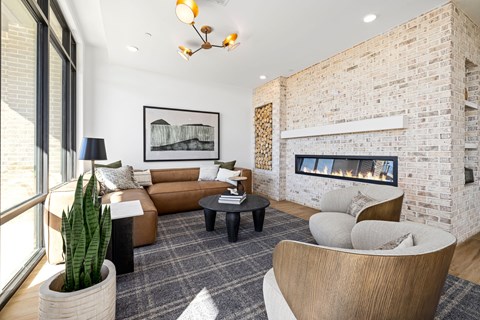 A modern living room with a fireplace and a large painting on the wall.