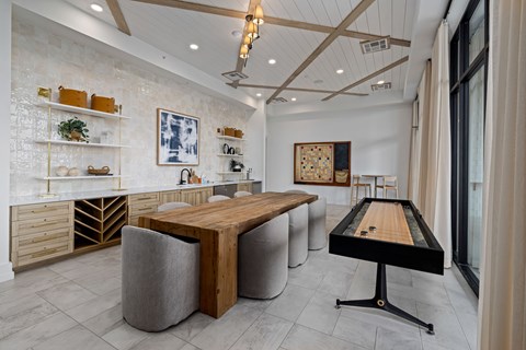 A room with a pool table and a shelf with various items on it.