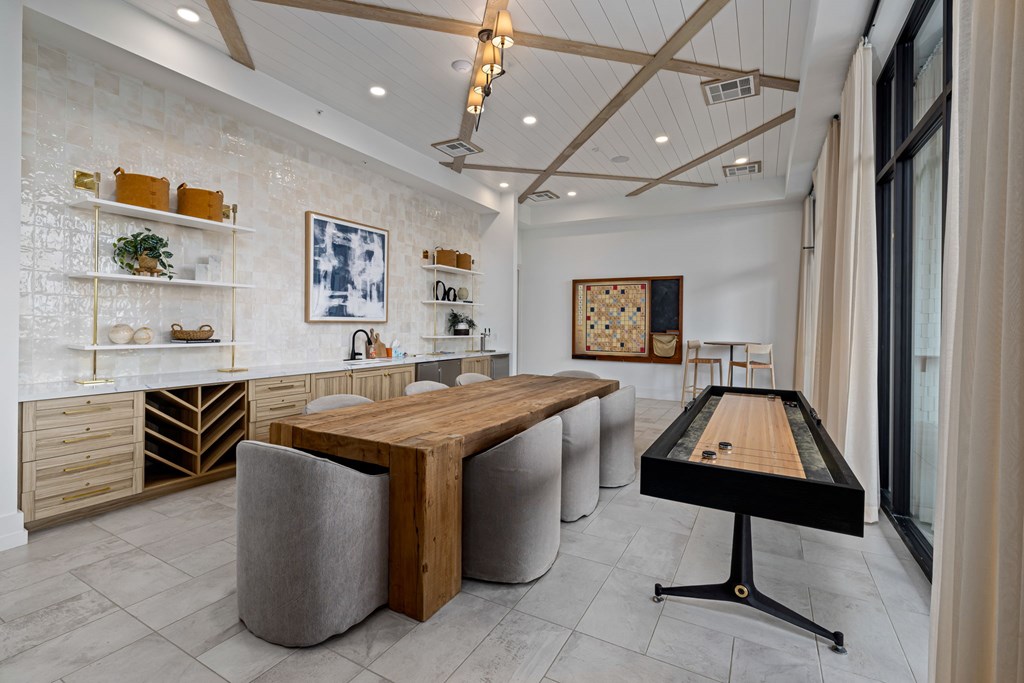 A room with a pool table and a shelf with various items on it.