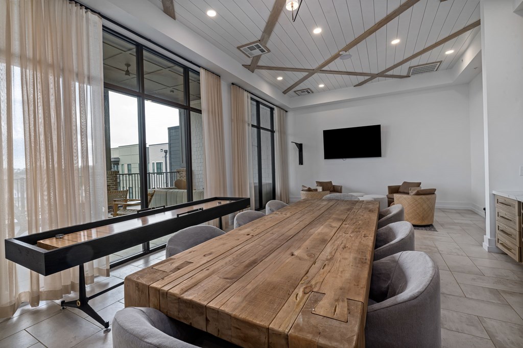A conference room with a long wooden table and chairs.