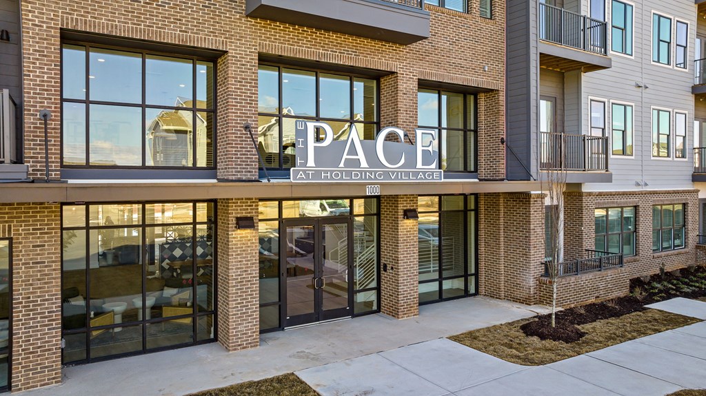 The Pace building at Holding Village is a modern, multi-story structure with large windows and a mix of brick and glass exteriors.