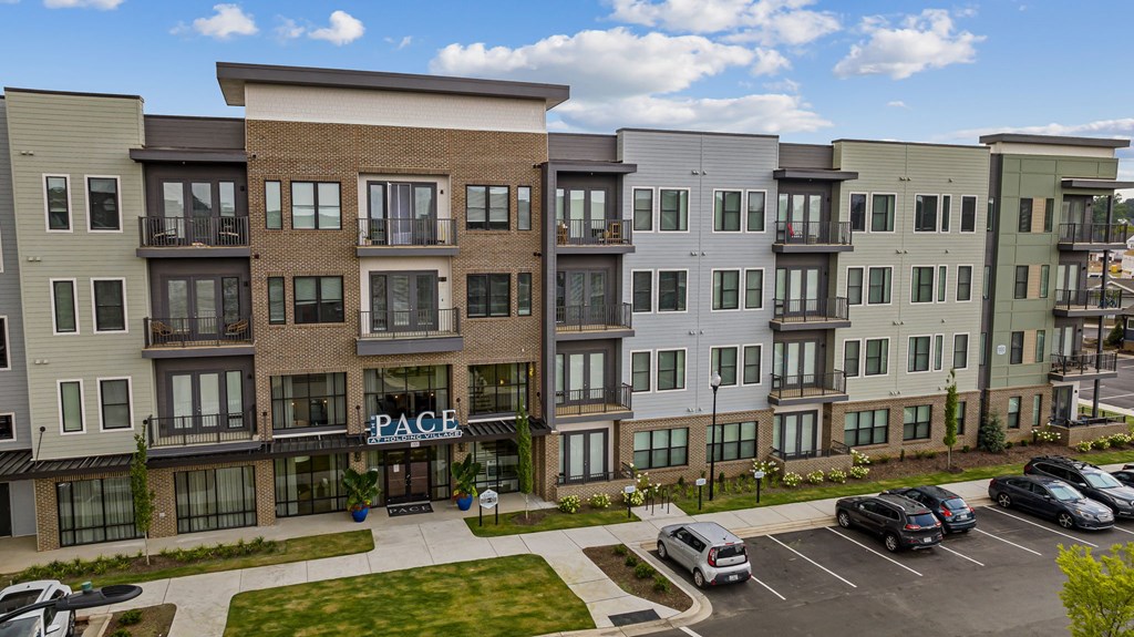 A multi-story apartment complex with the name "PACE" on the front.