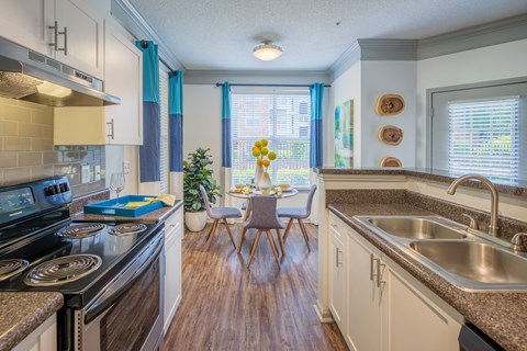 an open kitchen and dining room with a table and chairs