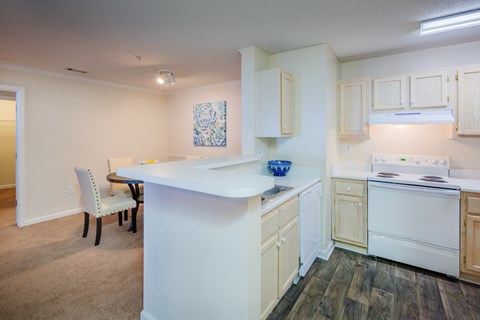 a kitchen with an island and a dining room with a table