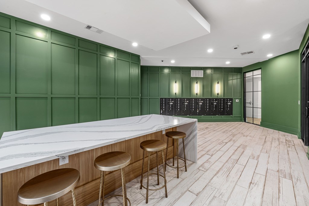 A bar area with a white counter and stools.