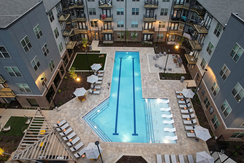 an overhead view of an apartment swimming pool in an apartment building