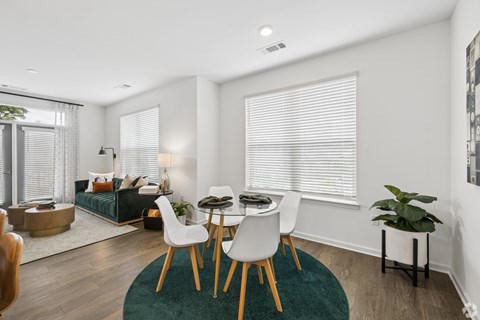 A dining room with a table and chairs.