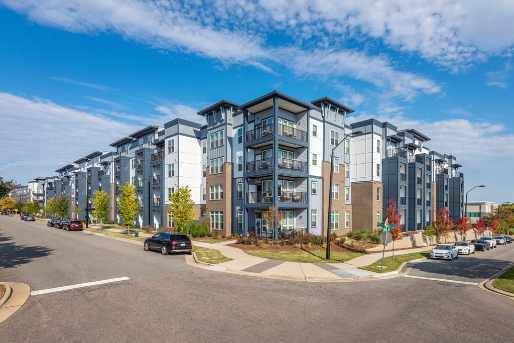 an apartment building on the corner of a city street