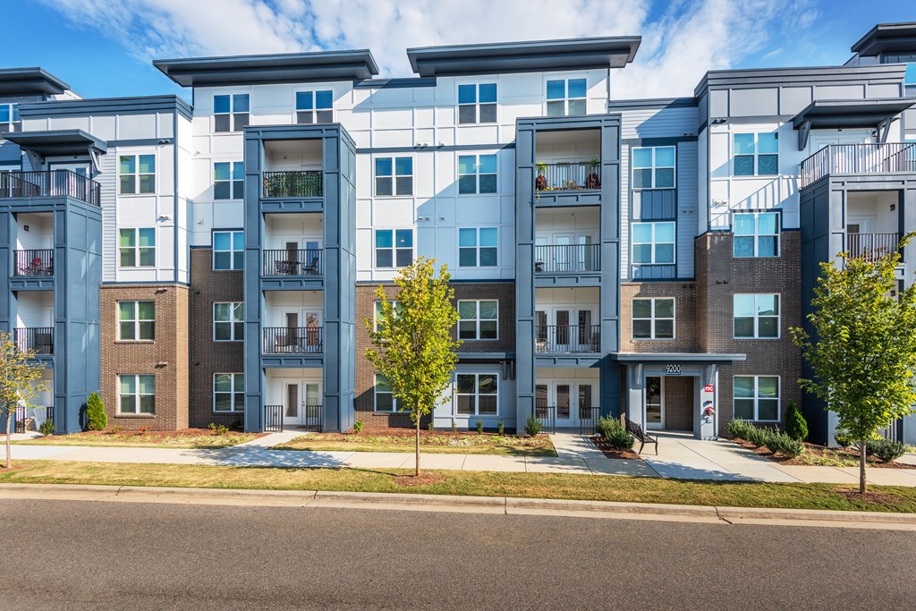 an exterior view of an apartment building on a city street