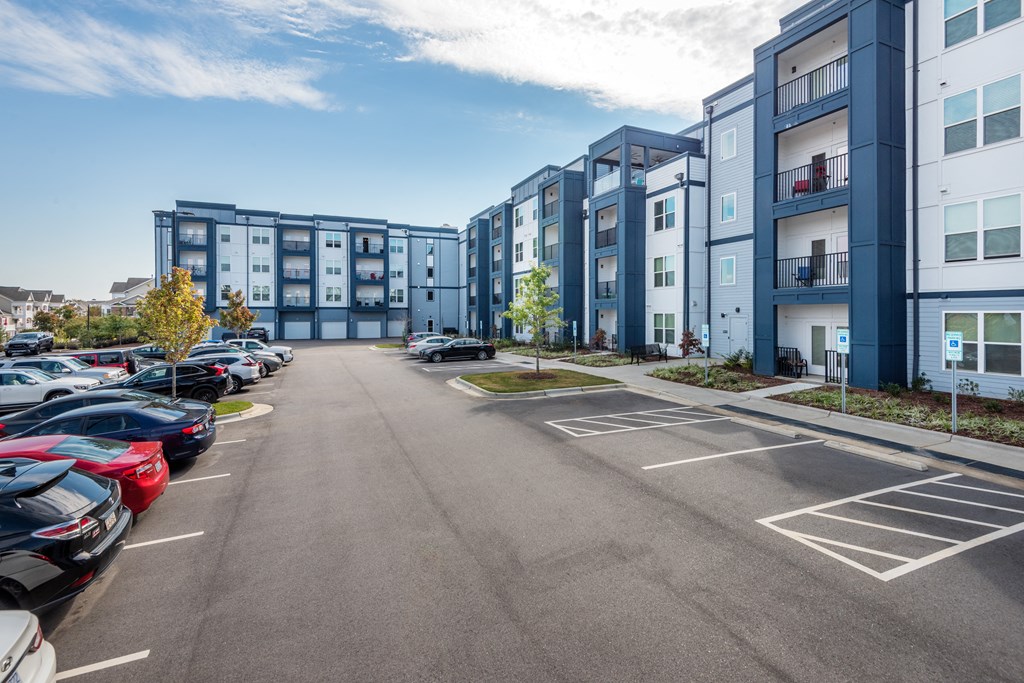 an empty parking lot in front of an apartment building