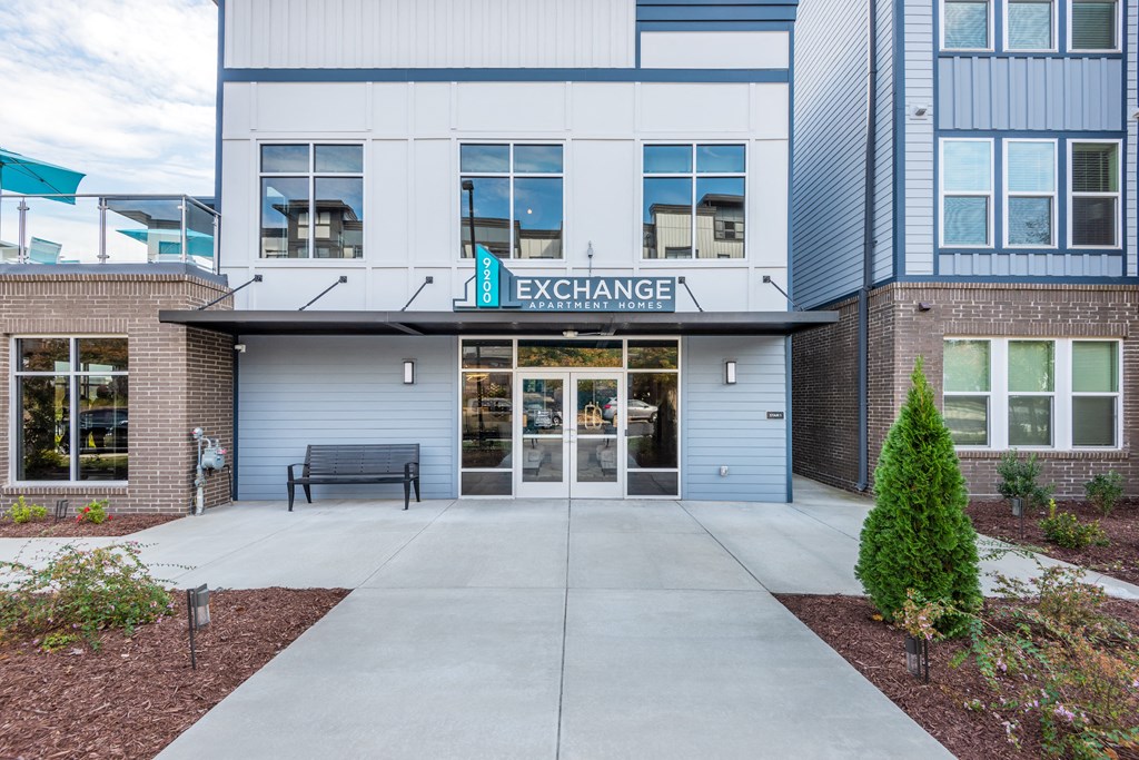 the entrance to a building with a bench in front of it