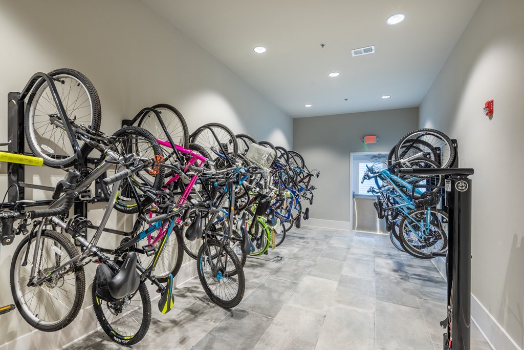 a row of bikes parked on a rack in a building
