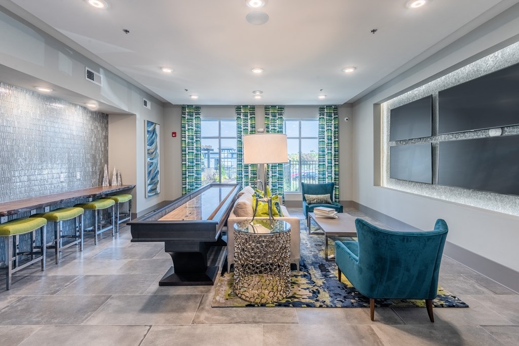 a living room with a piano and a table with chairs