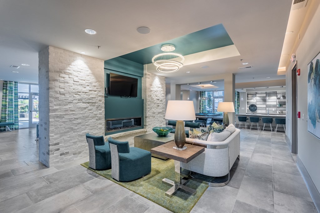 a living room with a couch and chairs and a television