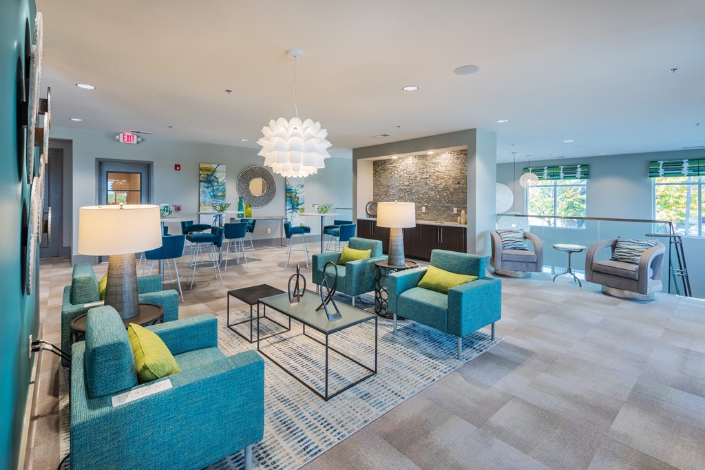 a lobby with blue couches and chairs and a bar