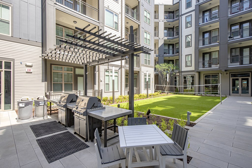 courtyard with grilling station and volleyball net