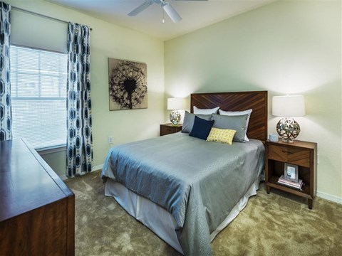 a bedroom with a bed and a window