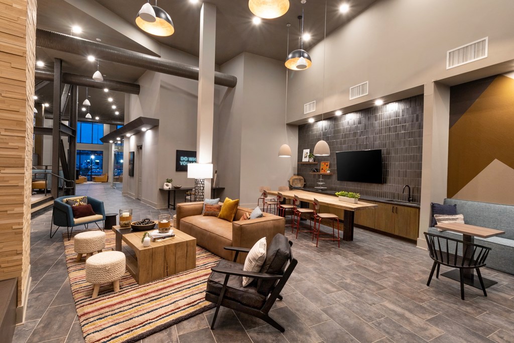 a living room with couches and chairs and a tv