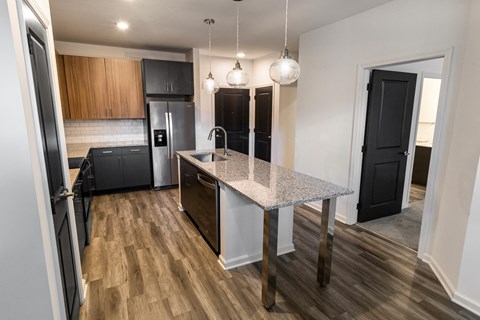 a renovated kitchen with a marble counter top in a new home