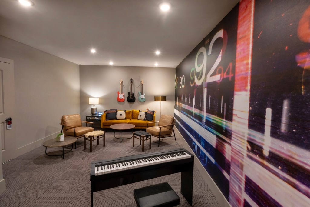 a living room with a piano and a large wall mural of a music album