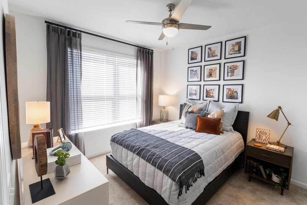 a bedroom with a bed and a ceiling fan