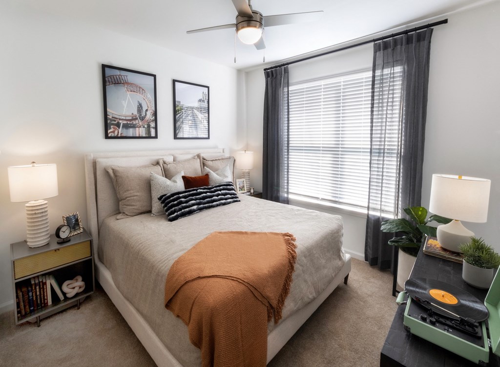 a bedroom with a large bed and a ceiling fan