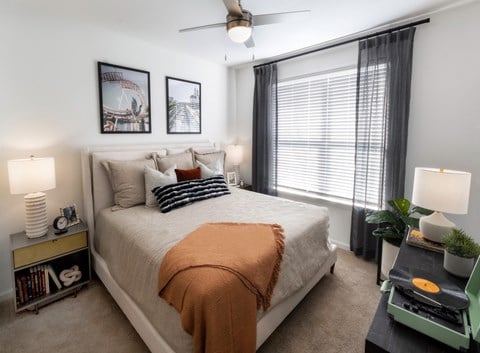 a bedroom with a large bed and a ceiling fan