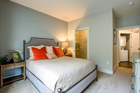 a bedroom with a bed and a door to a bathroom