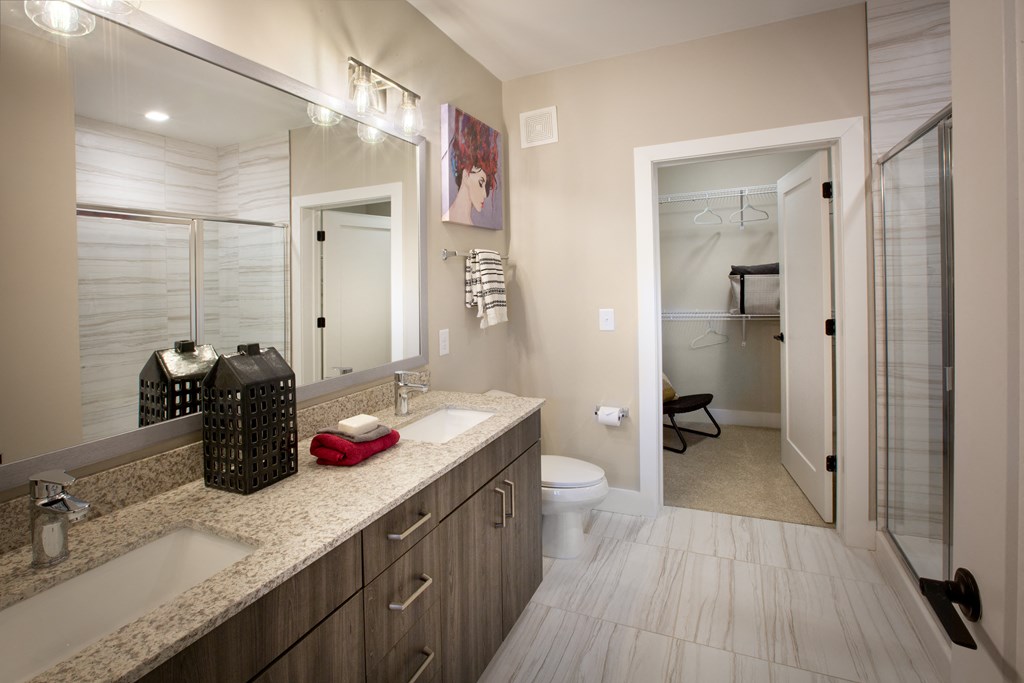 a bathroom with a sink and a toilet and a shower
