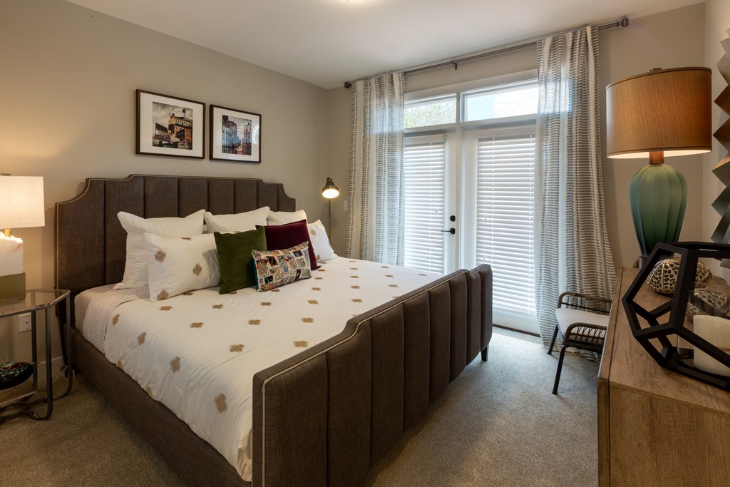 a bedroom with a large bed and a large window