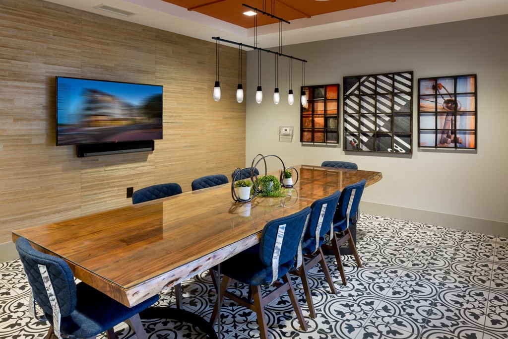 a dining room with a wooden table and blue chairs