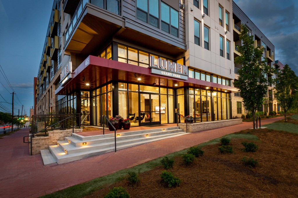 the building in which the hotel is located is lit up at night