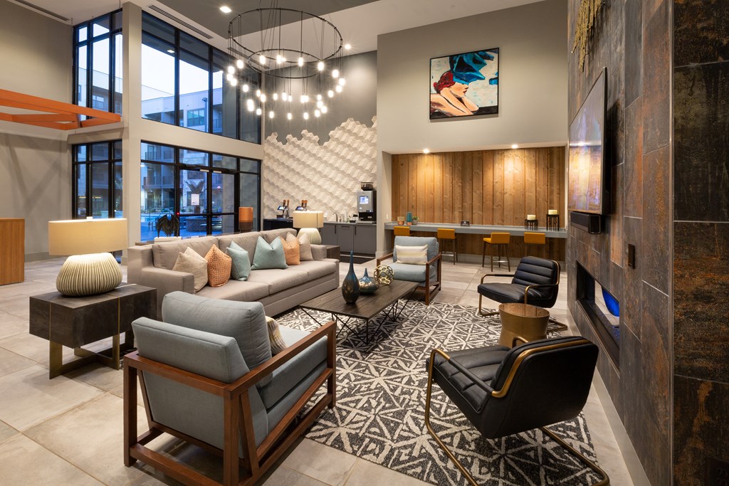 a living room with couches and chairs and a fireplace