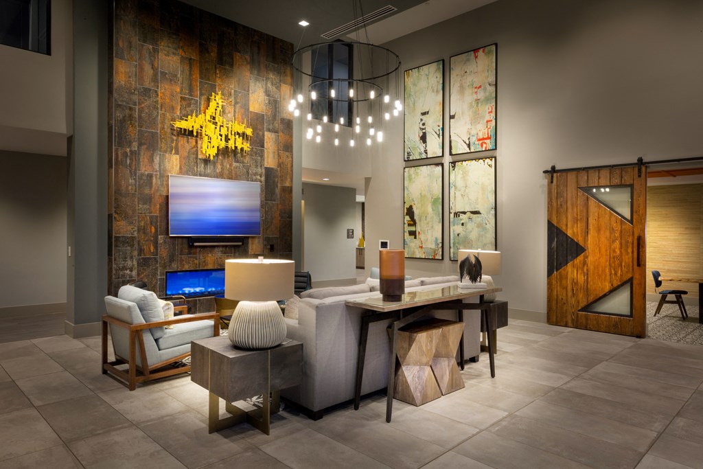 a living room with a dining room table and a television