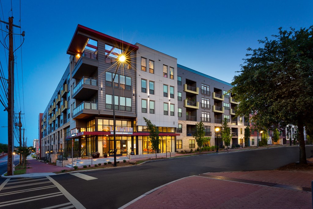 an exterior view of an apartment building at dusk