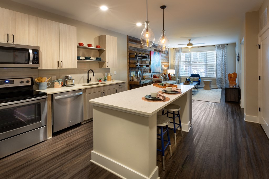 a kitchen with a large island and stainless steel appliances