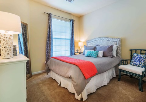 a bedroom with a large bed and a window