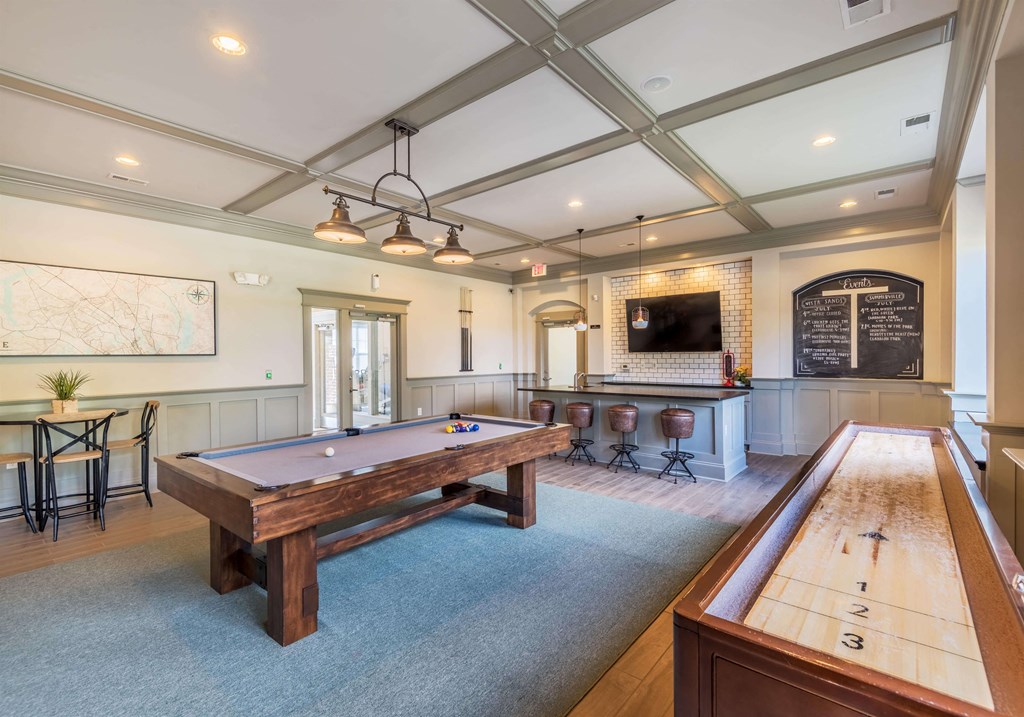 Clubhouse lounge game room with billiards and shuffleboard