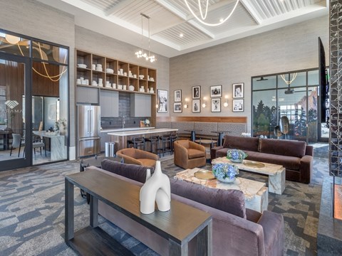 A modern living room with a purple couch and a wooden coffee table.