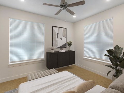 A modern living room with a white sofa and a ceiling fan.