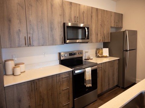A kitchen with wooden cabinets and stainless steel appliances.
