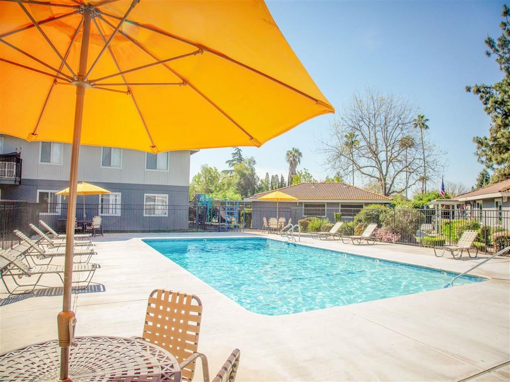 Pool With Sunning Deck at Courtyard at Central Park Apartments, California, 93722