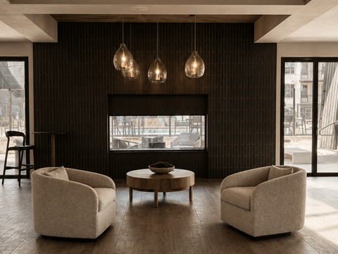 A living room with a fireplace, two chairs and a coffee table.