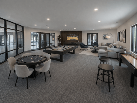 A modern living room with a dining table and chairs.