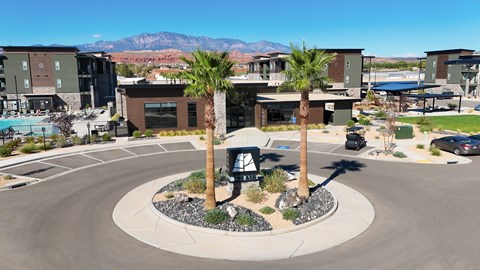 A roundabout with palm trees in the middle of a sunny day.
