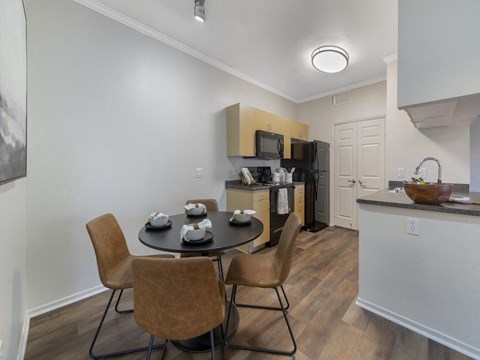 a kitchen and dining room with a table and chairs